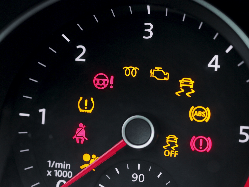 Car dashboard warning lights illuminated on ignition audit.